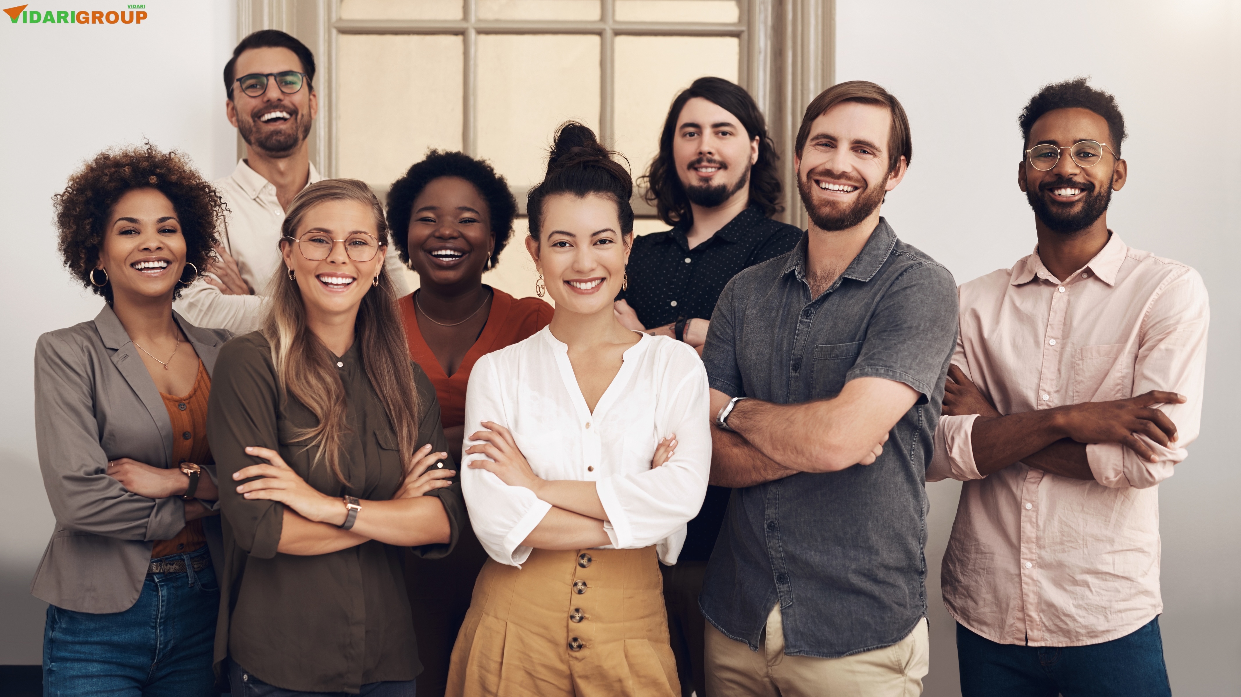 Vidari Group team members standing together in a professional office setting